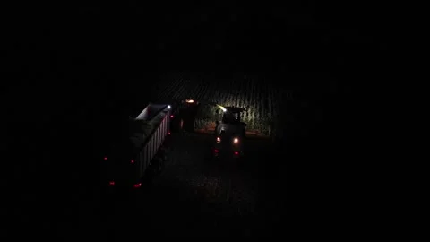 Green combine chopping corn silage in Ukraine at night Видео 298071428