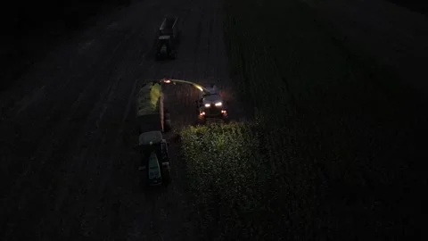 Green combine chopping corn silage in Ukraine at night 스톡 동영상 298071553