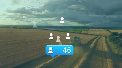 Green combine harvester moving through harvested field, showing social icons and Stock Footage 308206972