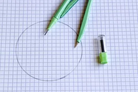 Green compass, on the math notebook Stock Photos