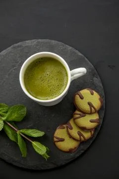 Green composition with match tea and cookies for healthy breakfast Stock Photos