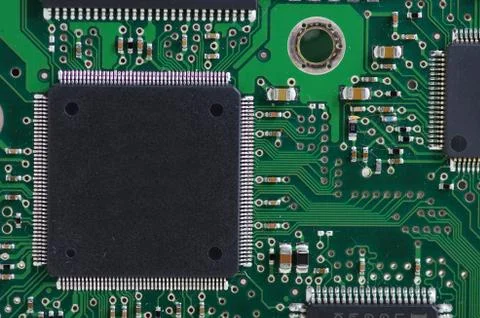 Green computer board with chips and components. Stock Photos