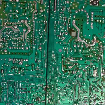 Green computer circuit board as a background. Chip. Stock Photos