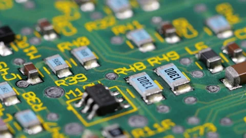 Green computer circuit board full of chips with yellow letters and numbers Stock Footage 141340478