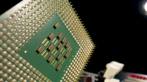 Green computer CPU microprocessor or processor on a black background. Close up Stock Photos