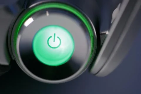 Green computer power on glowing button Stock Photos
