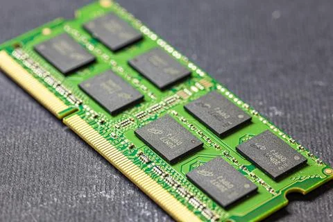 Green computer ram memory module closeup lying on dark background Stock Photos