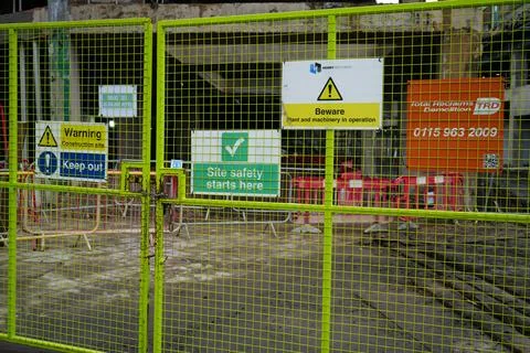 Green Construction Site Fence With Warning Signs In Nottingham, England Photos