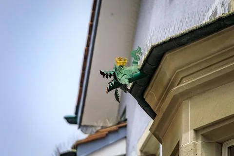 Green copper dragon gargoyle gutter spout on stone facade in Zurich, Switze.. Stock Photos