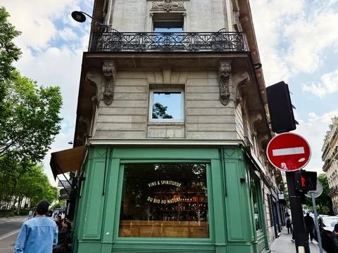 Green corner cafe storefront and historic Paris, France street scene with n.. Stock Photos