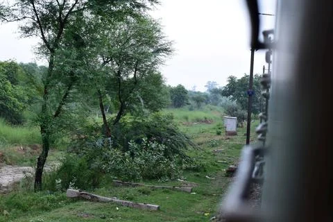 Green countryside viewed through the window of a moving train Stock Photos