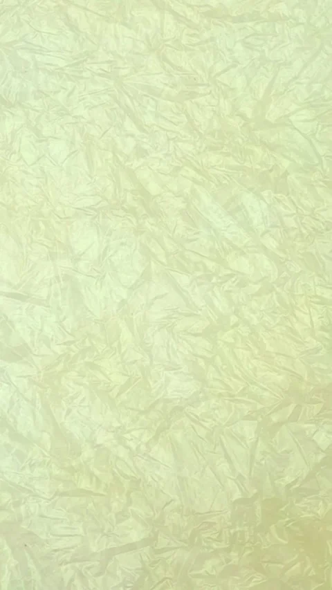 Green crumpled plastic bag texture background rotating. Low-Density Polyethylene Stock Footage 316379180