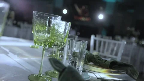 GREEN CRYSTAL GLASSES ON THE TABLE Stock Footage 300031369