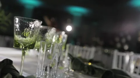 GREEN CRYSTAL GLASSES ON THE TABLE Stock Footage 300031372