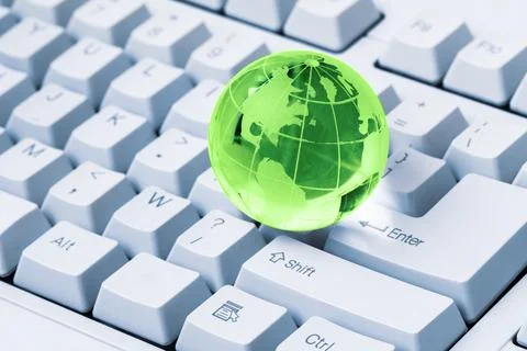 Green crystal globe of the Earth on a computer keyboard Stock-Fotos