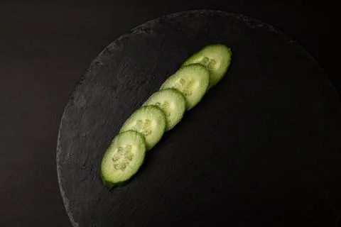 Green cucumber on black background Stock Photos