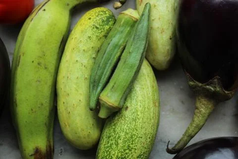 Green cucumber display with selective focus and fresh various raw organic vegeta Stock Photos