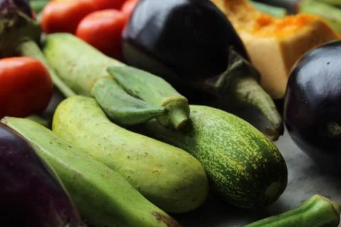 Green cucumber display with selective focus and fresh various raw organic vegeta 库存照片