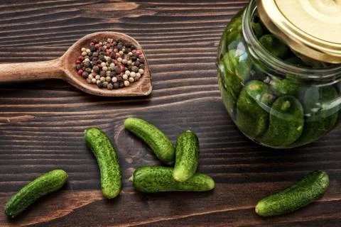 Green Cucumbers, Back and Red Pepper on the Wooden Table Stock Photos