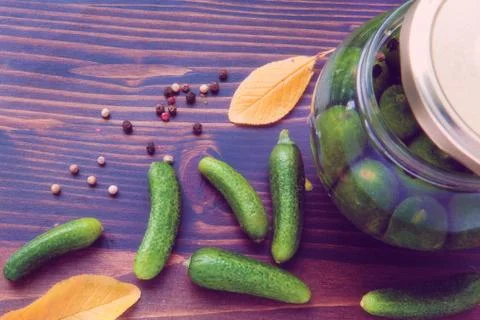 Green Cucumbers, Back and Red Pepper on the Wooden Table Stock Photos