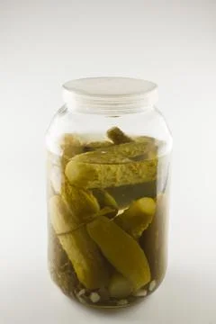 Green cucumbers in marinade Stock Photos