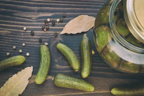 Green Cucumbers, Pepper, Bay Leaf  on the Wooden Table Stock Photos