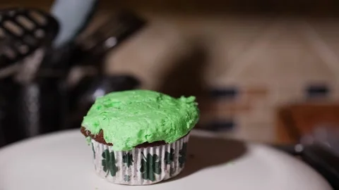 Green cup cake bouncing off each other in slow motion at St Patick's Day Stock Footage 150607545