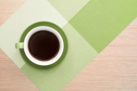 Green cup of coffee on the table background and tablecloth Stock Photos