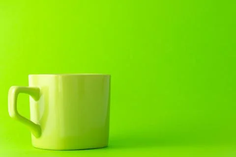 Green cup isolate on green background Stock Photos