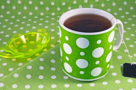 Green cup of tea on a table Stock Photos