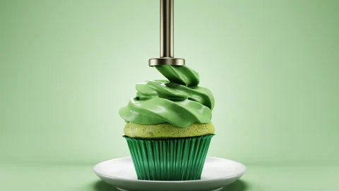 A green cupcake under pressure in the style of St. Patrick's Day Stock Footage 303421618