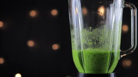 Green detox smoothie in blender on black background, super slow slow motion Stock Footage