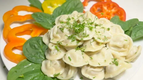 Green dill falls down on the meet dumplings or pelmeni Stock Footage 63780803