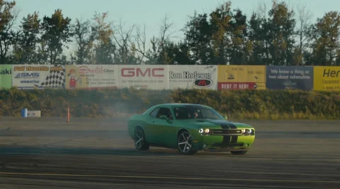 Green Dodge Challenger going into a spin out while drifting. Stock Footage