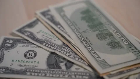 Green dollar bills fall stack on wooden background, banknotes Vidéo 147537955