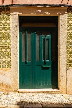 Green Door Framed by Patterned Tiles in Lisbon Stock Photos