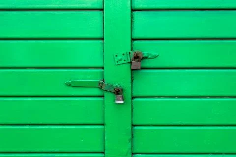 Green door with locks Foto stock