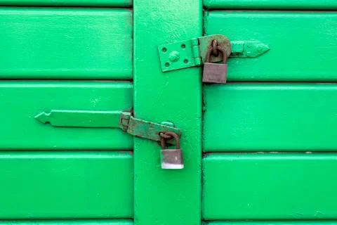 Green door with locks Stock Photos