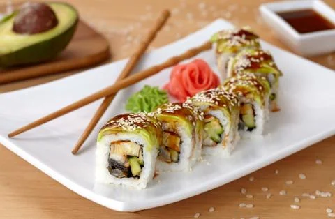 Green dragon sushi roll with eel, avocado, cucumber, wasabi and ginger Stock Photos
