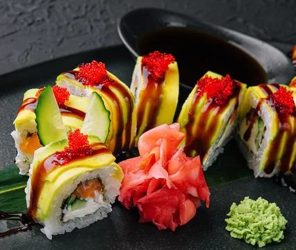 Green dragon sushi roll with eel on black stone Stock Photos