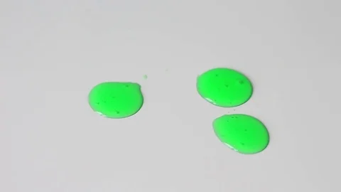 Green drops on a white surface Видео 71950459