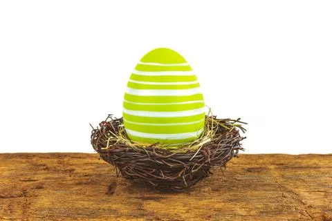 Green easter egg on a wooden table isolated on white Stock Photos