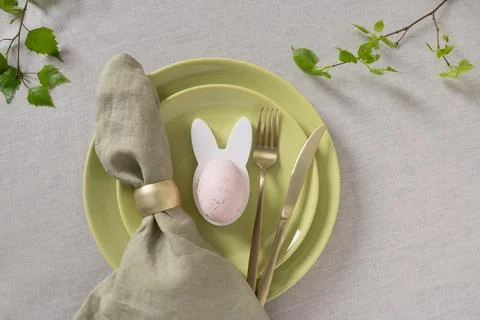 Green Easter table setting with bunny egg holder Stock Photos