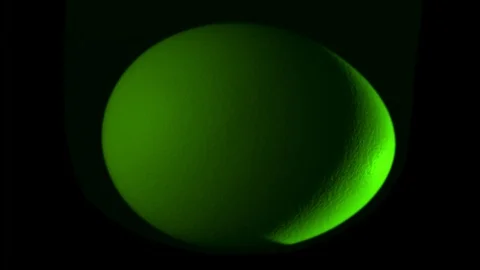 Green egg rotates on black background Stock Footage 104732589