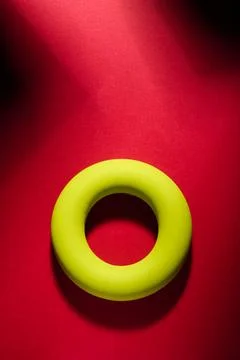Green elastic rubber ring on a red table Stock Photos