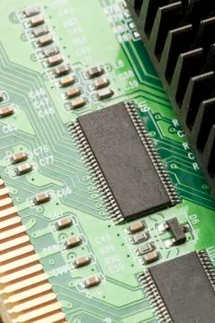 Green electrical circuit board with microchips and transistors Stock Photos