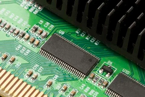 Green electrical circuit board with microchips and transistors Stock Photos