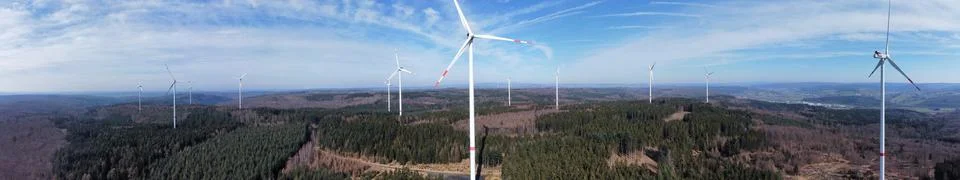 Green electricity future Panoramic view of wind turbines Stock Photos