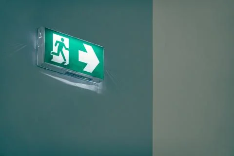 Green emergency exit or fire exit hanging sign Stock Photos