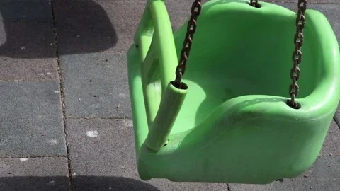 Green empty swing in the park Stock Footage 175162757